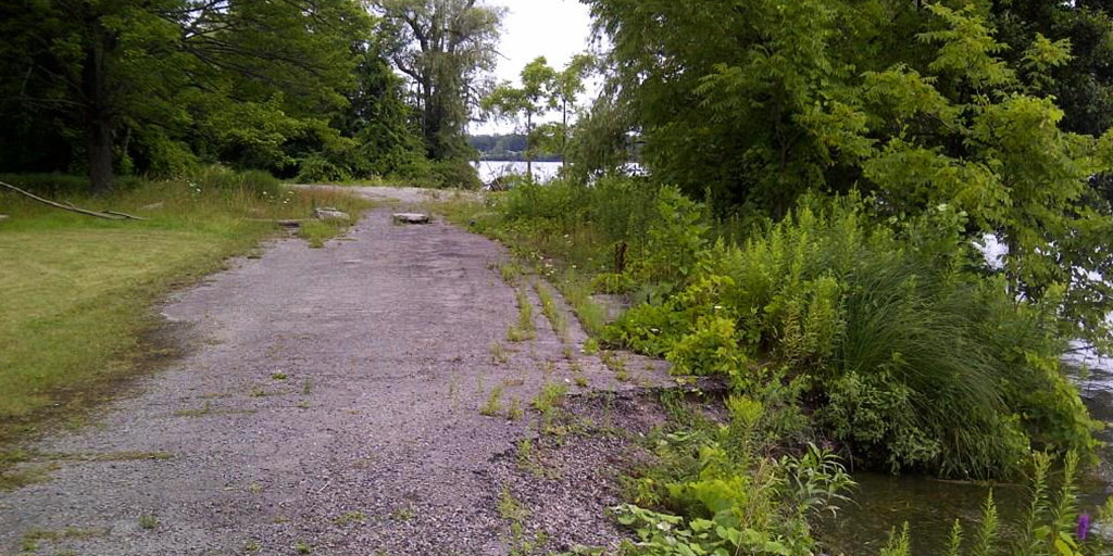 Former service road at Gonder’s Flats with hardened shoreline eroding into the Niagara River (Image: NPC).