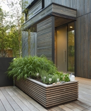 A large custom planter provides space for an herb garden beside the kitchen.