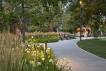 Drifts of ornamental grasses and perennials create softly veiled spaces within the dappled shade of the "Grove"