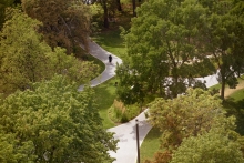 Quiet spaces under dappled shade and veiled by light ornamental grasses provide areas of respite in the park.