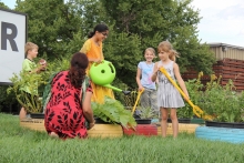 Children, parents and teachers work together on the Veggie Hill to cultivate their gardens.
